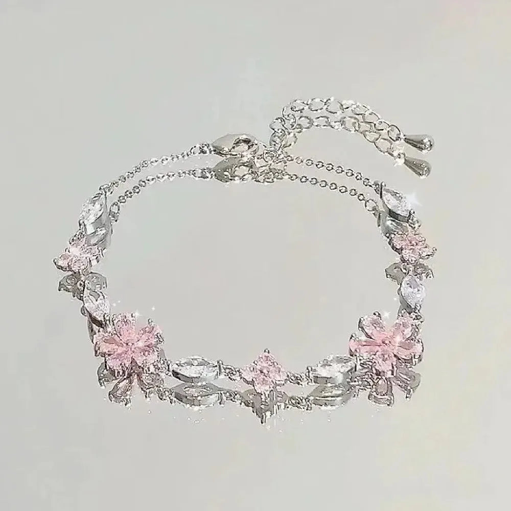 Pulsera Flor de Cerezo Rosa con Cristales – Diseño Luna y Moño Ajustable.