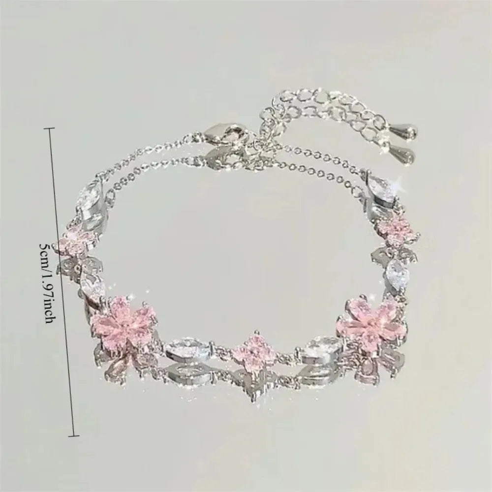 Pulsera Flor de Cerezo Rosa con Cristales – Diseño Luna y Moño Ajustable.